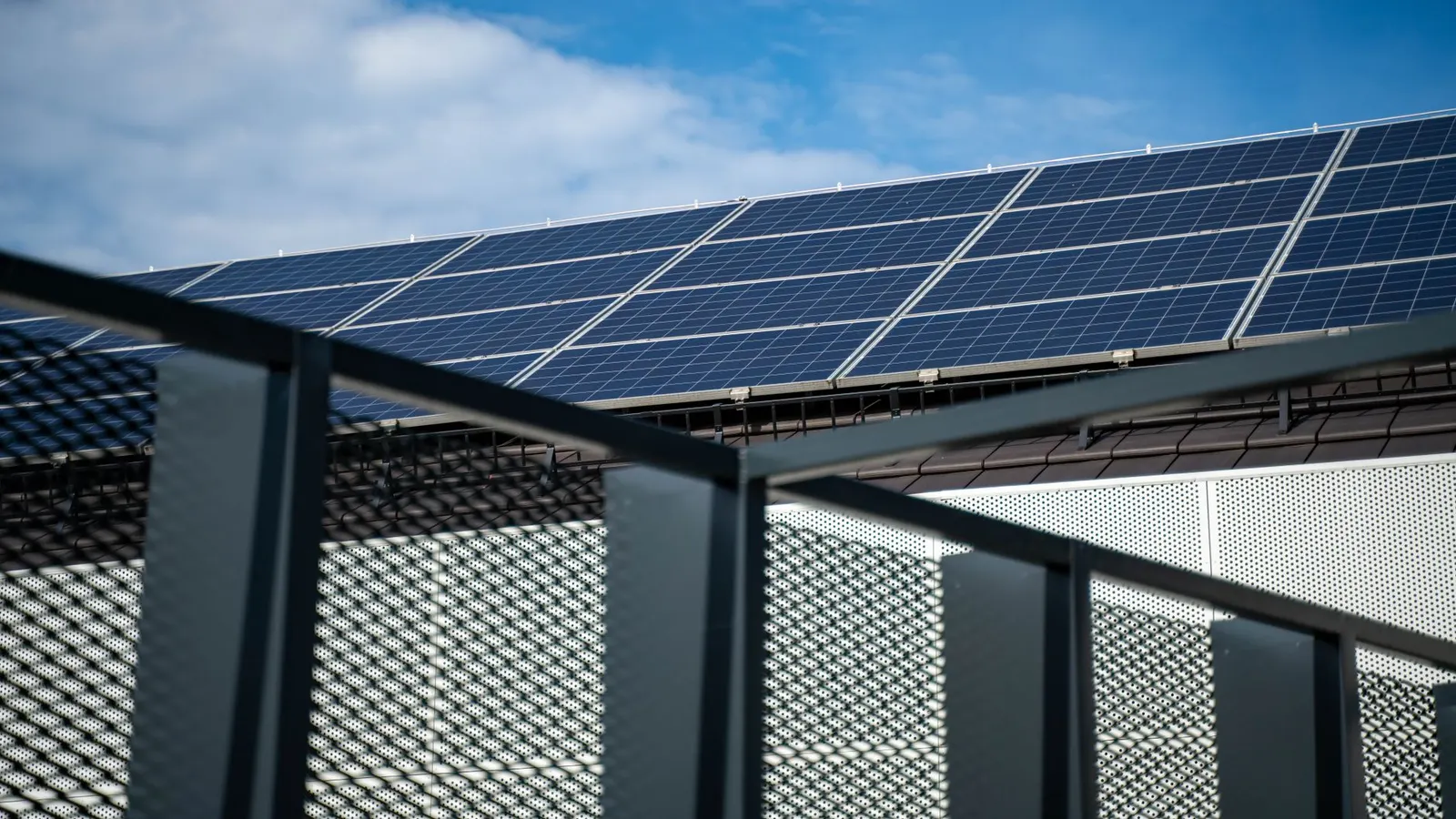 A rooftop solar panel array against a blue sky
