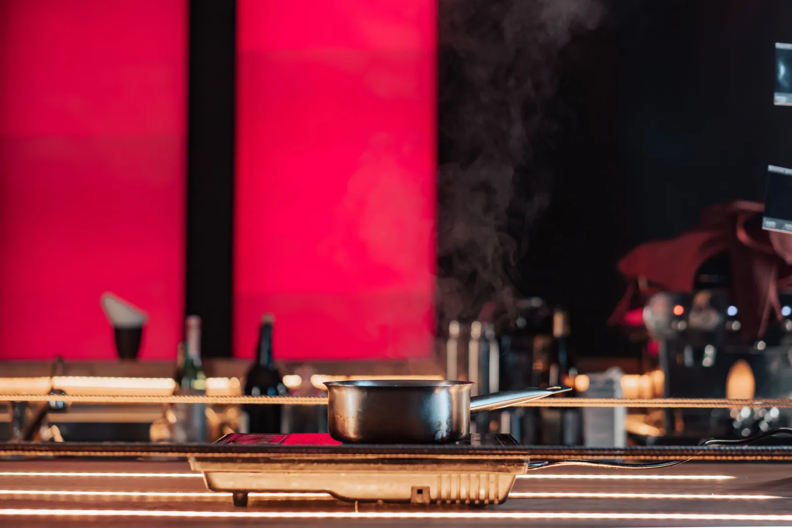 A steaming saucepan on a portable countertop electric hotplate