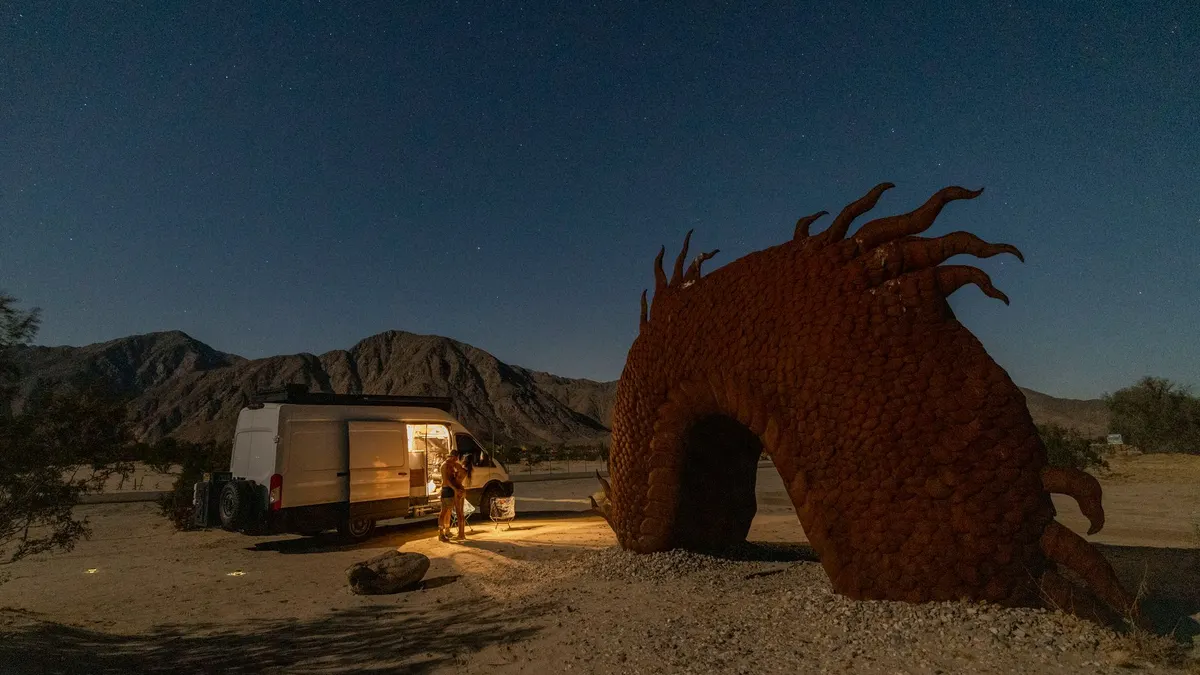 A van camped on open desert land