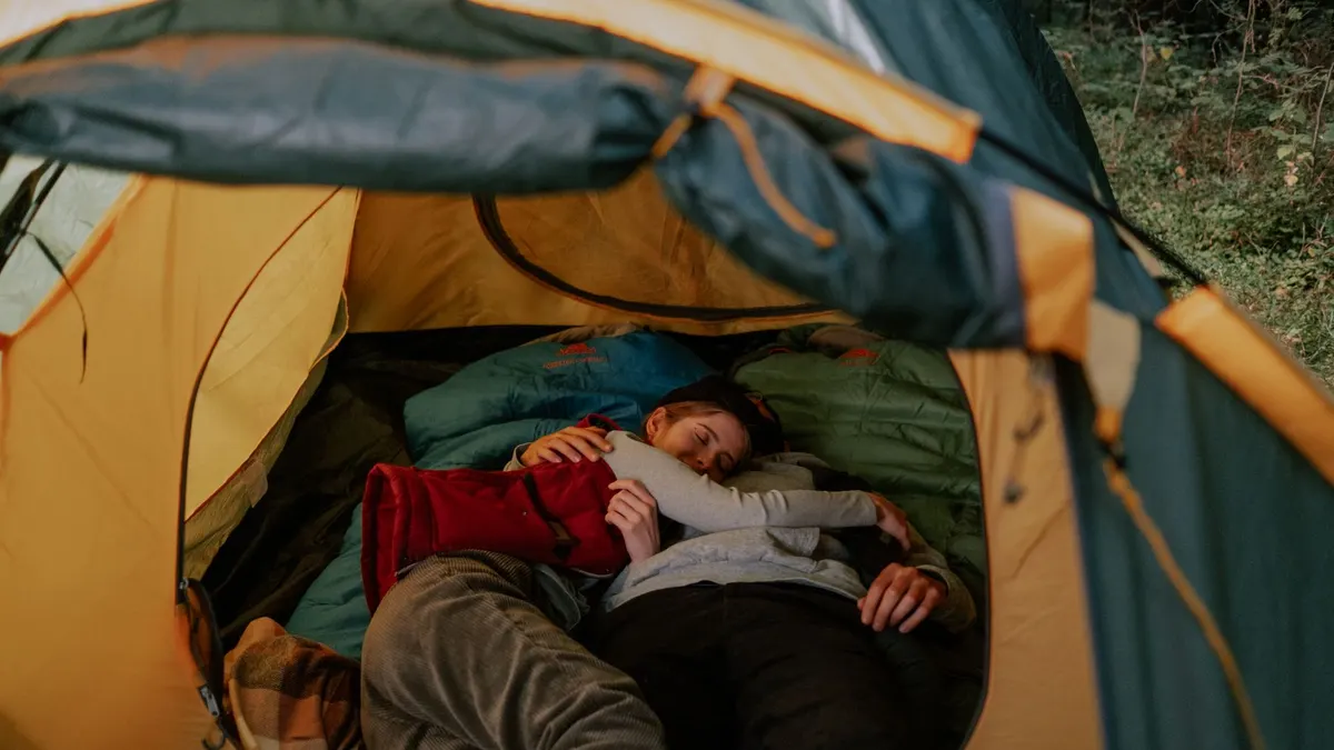 A sleeping bag laid out inside a tent