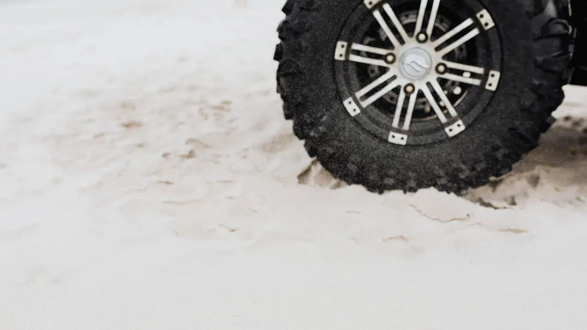 Vehicle wheel dug into sand