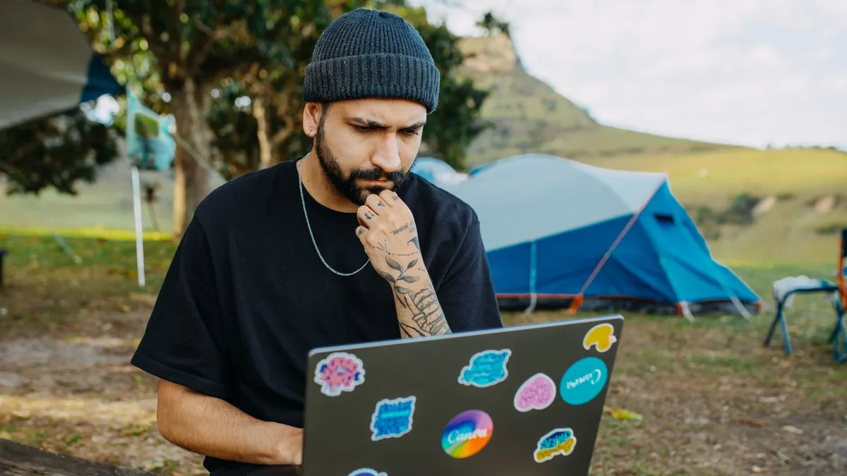 Working on a laptop at a camp table