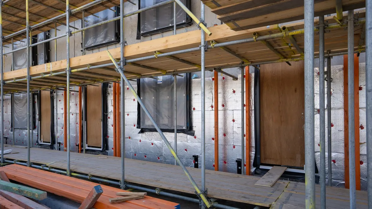 Insulation being fitted to a wall